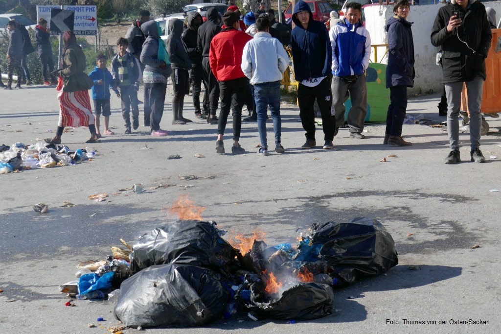 Brennende Plastiksäcke in einem Geflüchtetenlager auf Lesbos